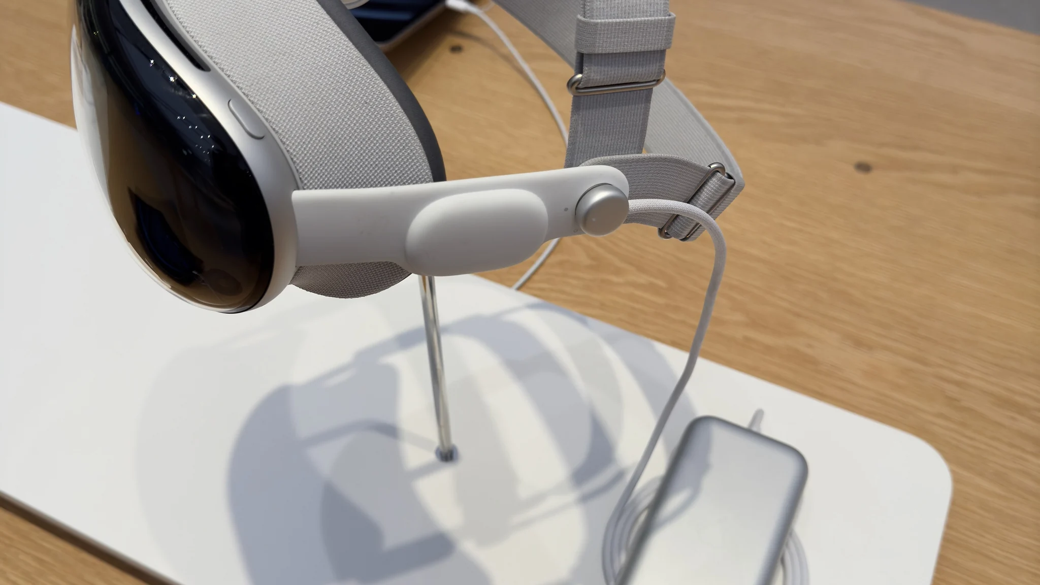 Apple Vision Pro headset on display at a retail table.